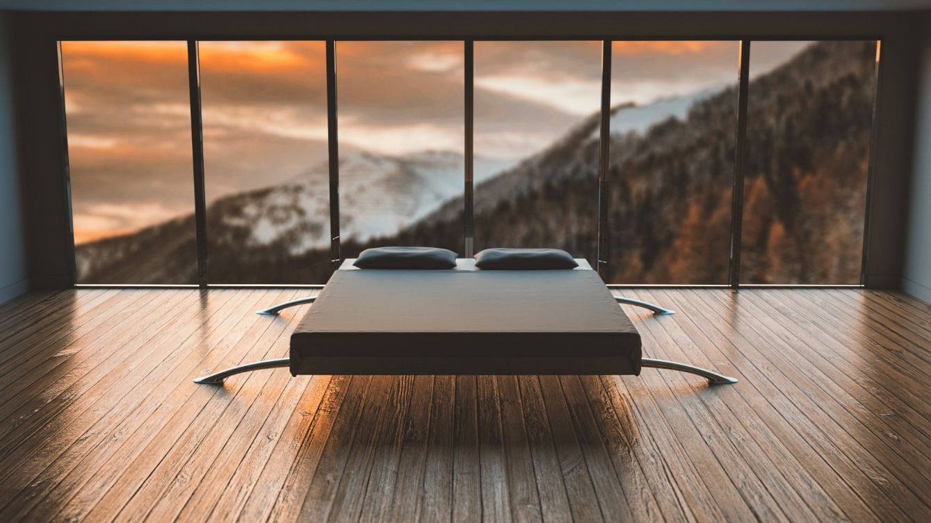 unique mattress foundation in middle of the room with sunset behind